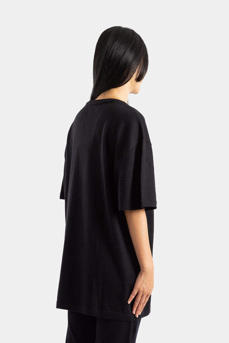 Extreme Cashmere oversized black cashmere t-shirt back view, with a long draped fit and straight shoulders.