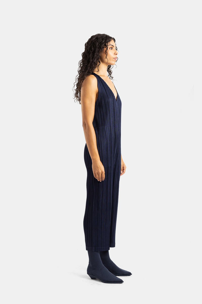 Tuta donna Pleats Please Issey Miyake vista di profilo in tessuto micro-plissé blu marine e silhouette fluida