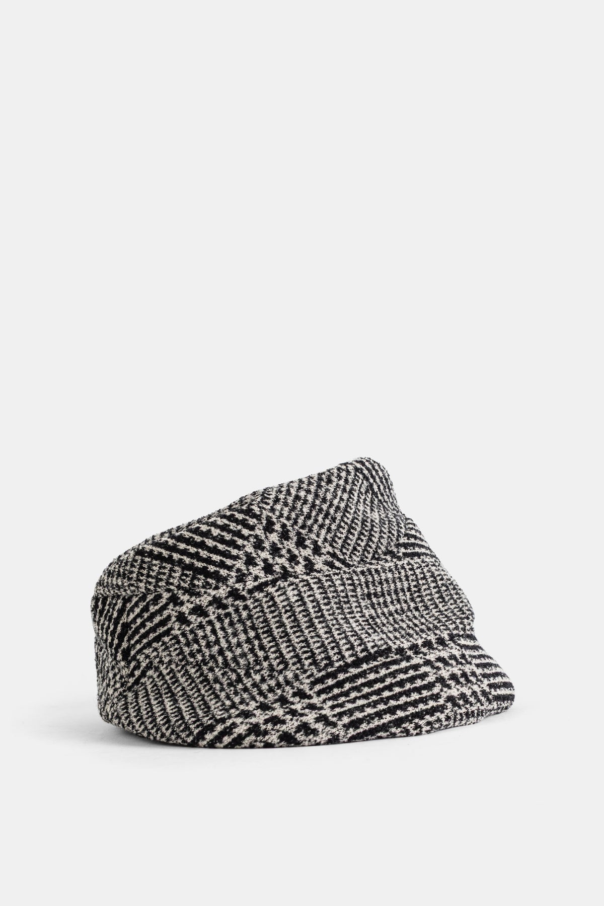 Cappello donna Junya Watanabe stile tweed jacquard monocromo posato in piano con motivo geometrico bicolore.