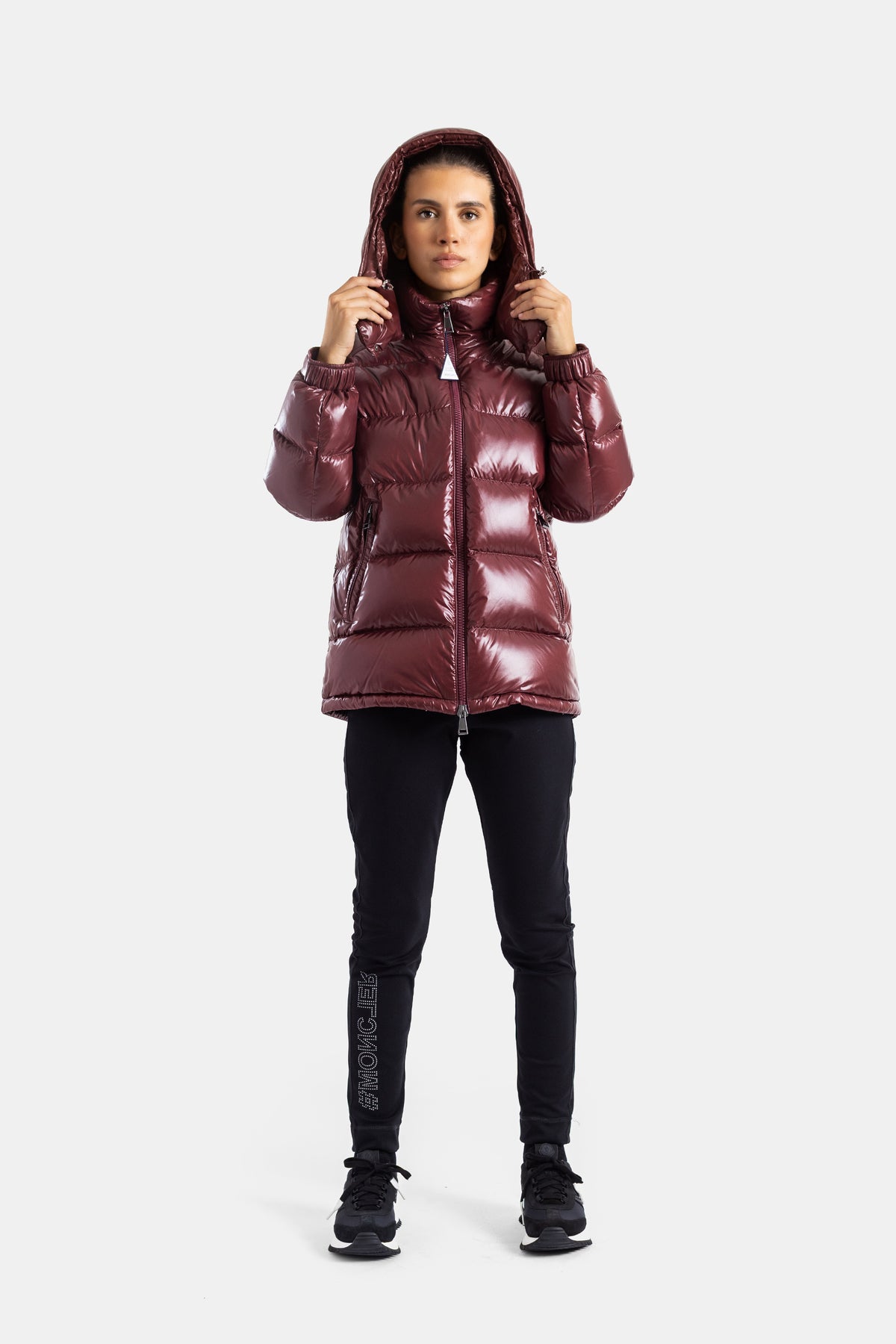 Moncler Maire Daunenjacke in Bordeaux mit Kapuze, getragen mit schwarzer Logo-Leggings im Luxus-Sport-Look