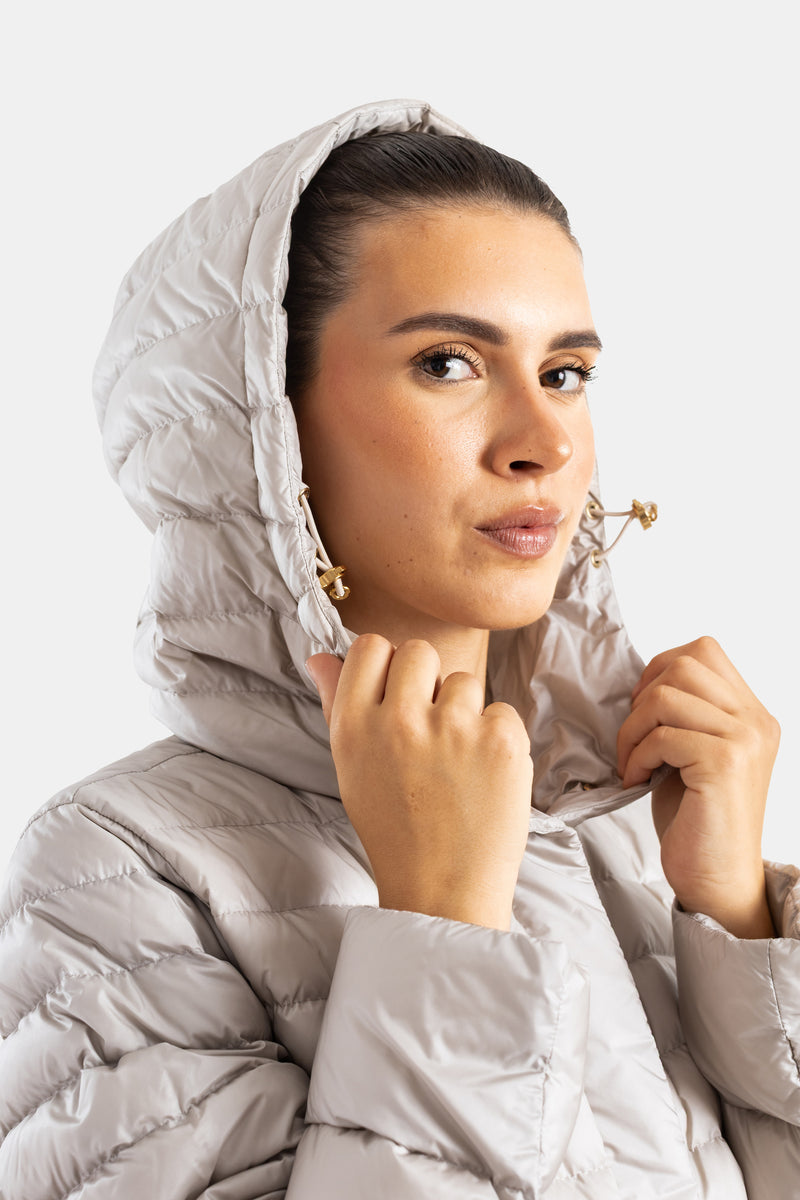 Moncler women's down jacket, fitted hood, gold drawstrings, close-up face, pearlescent finish, grège colorway