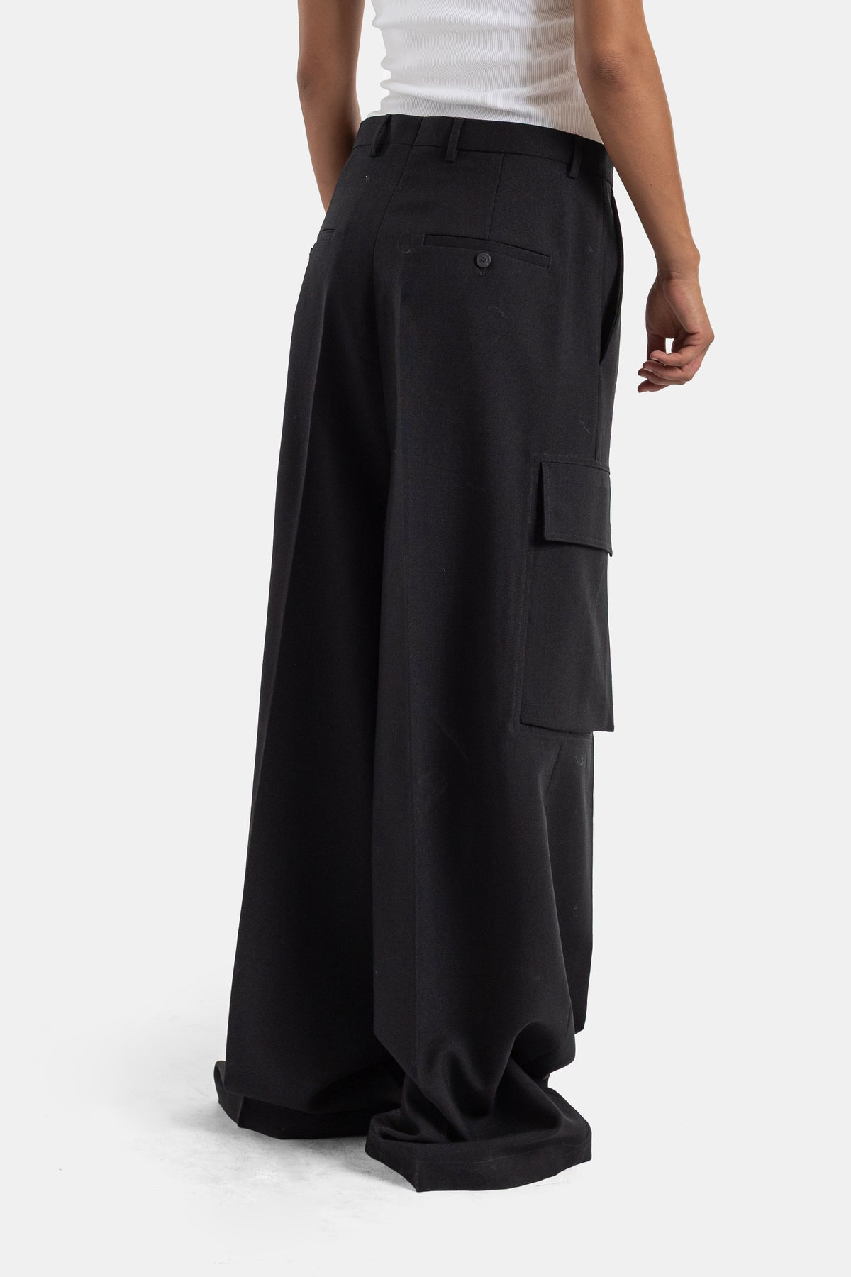 Rick Owens black cargo trousers back view with thigh patch pocket and buttoned tab, oversize women's palazzo cut