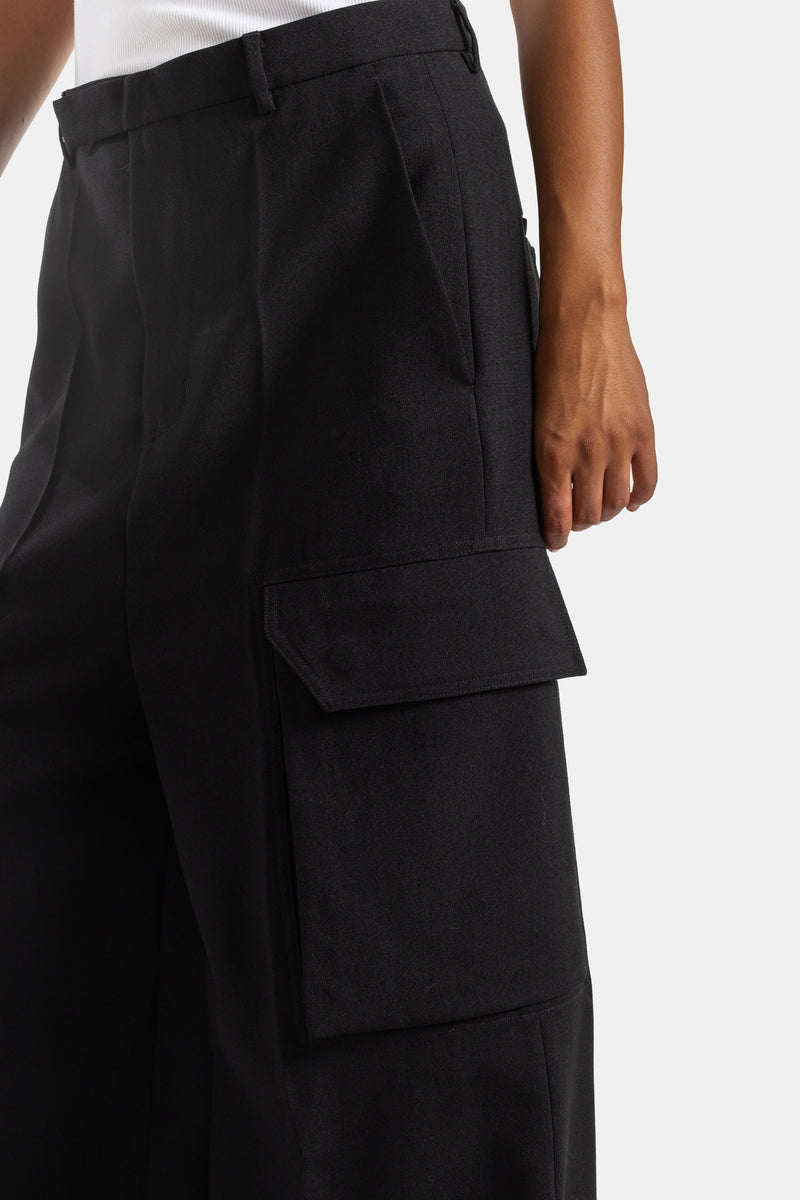 Detailed close-up of Rick Owens black cargo trousers thigh flap pocket, high-waisted wide-leg cut for women