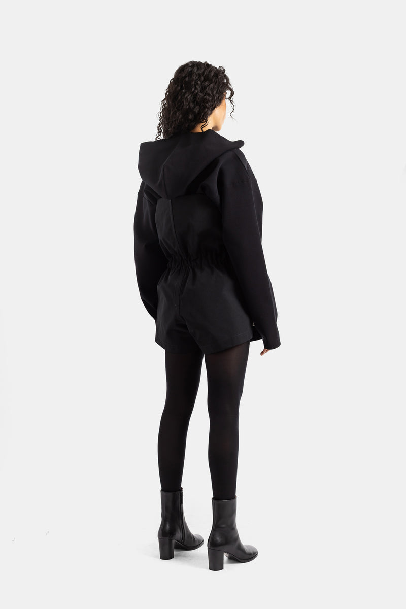 Women's black Rick Owens playsuit, back view with structured hood, elasticated gathered hem and black leggings