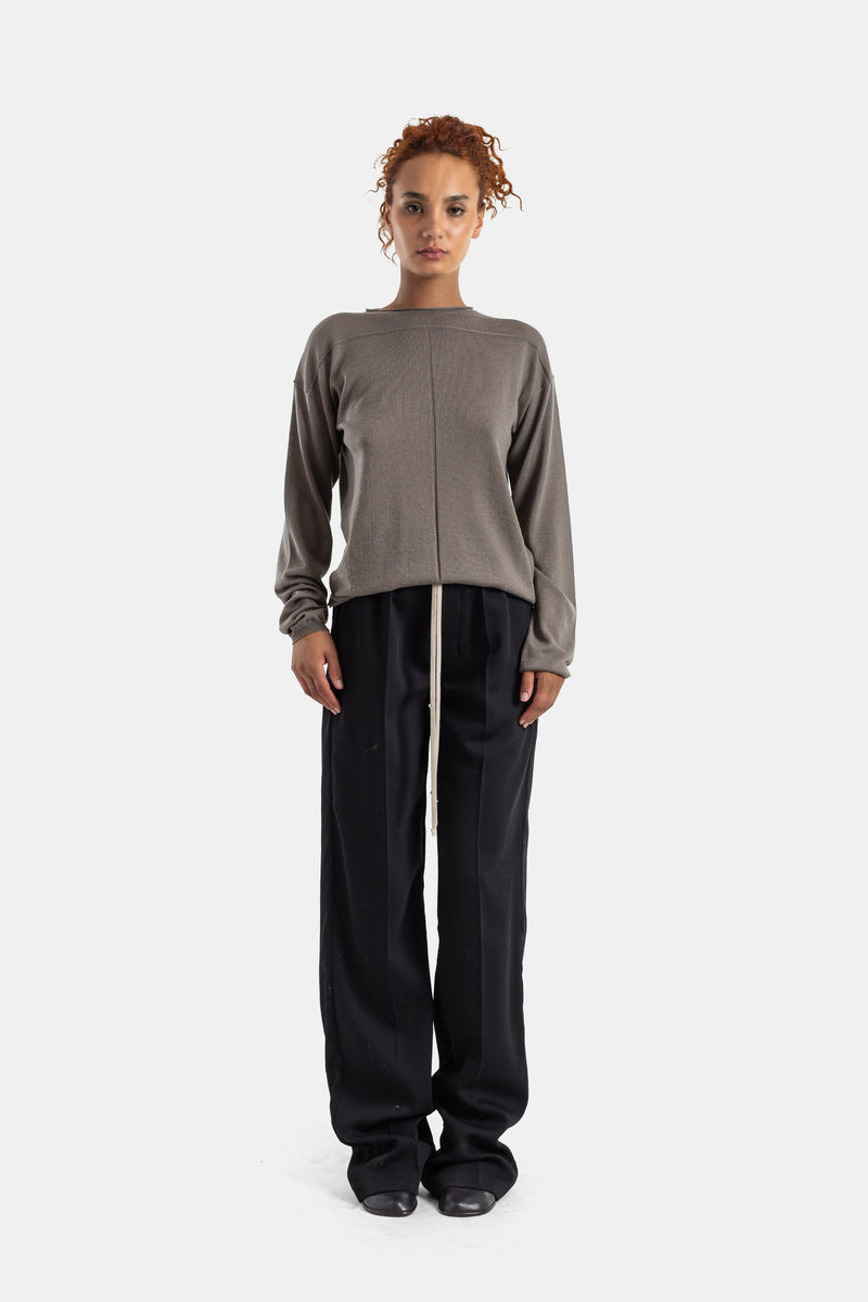 Rick Owens taupe Level sweater worn with wide black trousers for a luxury minimalist oversized silhouette.