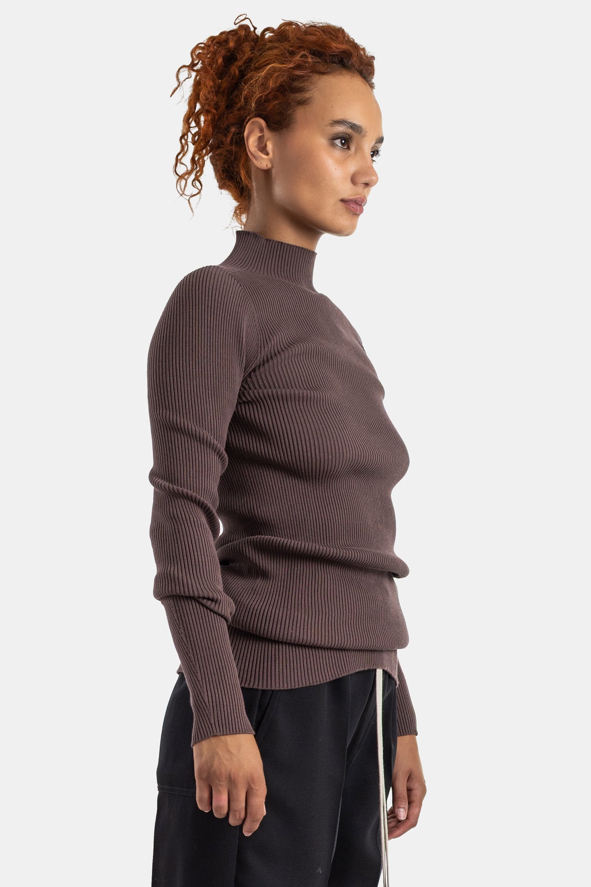 Three-quarter profile of Rick Owens women's close-fitting ribbed knit mock neck sweater in chocolate brown