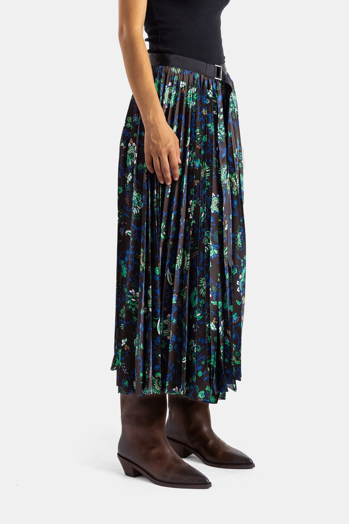 Sacai jupe midi plissée vue de profil, tombé fluide imprimé botanique vert et bleu sur fond sombre