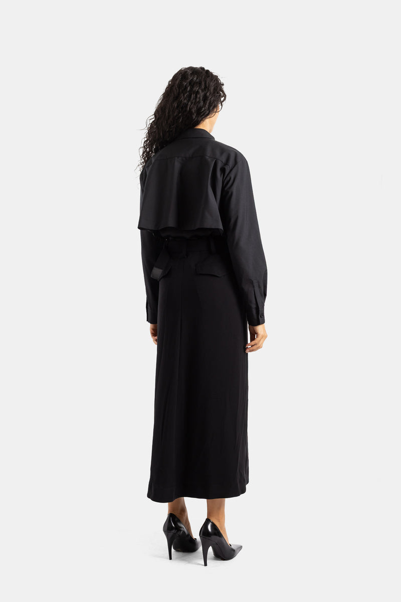 Sacai long black dress with cropped layered jacket back, knotted belt, satin crepe, and high stiletto heels.