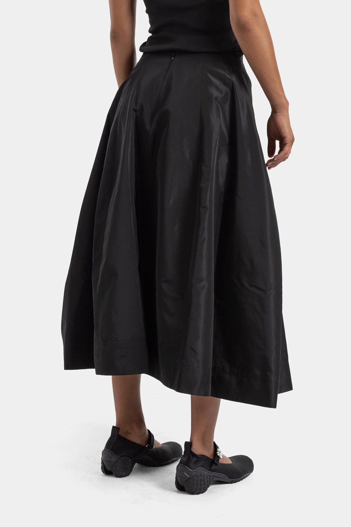 Back view of Simone Rocha black midi skirt, flared drape in sateen cotton with high-waist zipper closure
