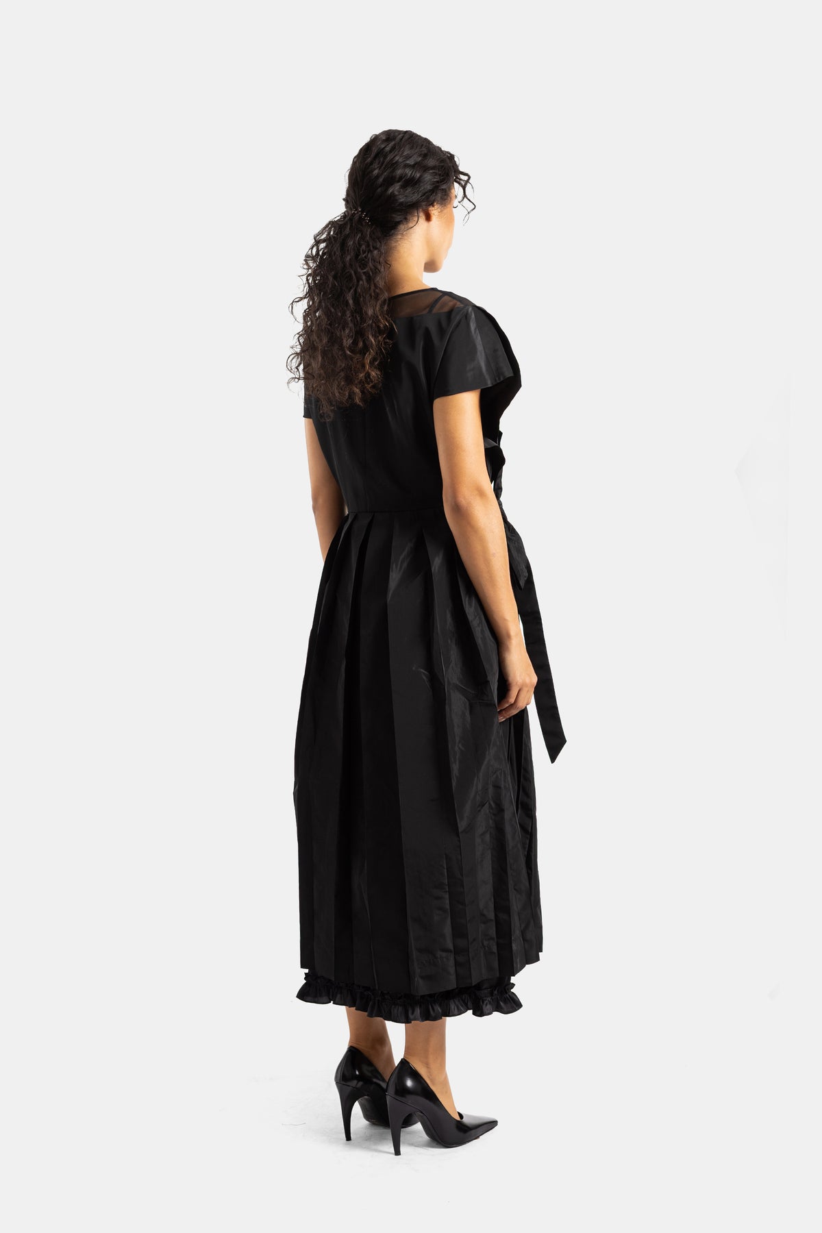 Simone Rocha black backless dress in crinkled taffeta with tied ribbon detail and gathered ruffle hem