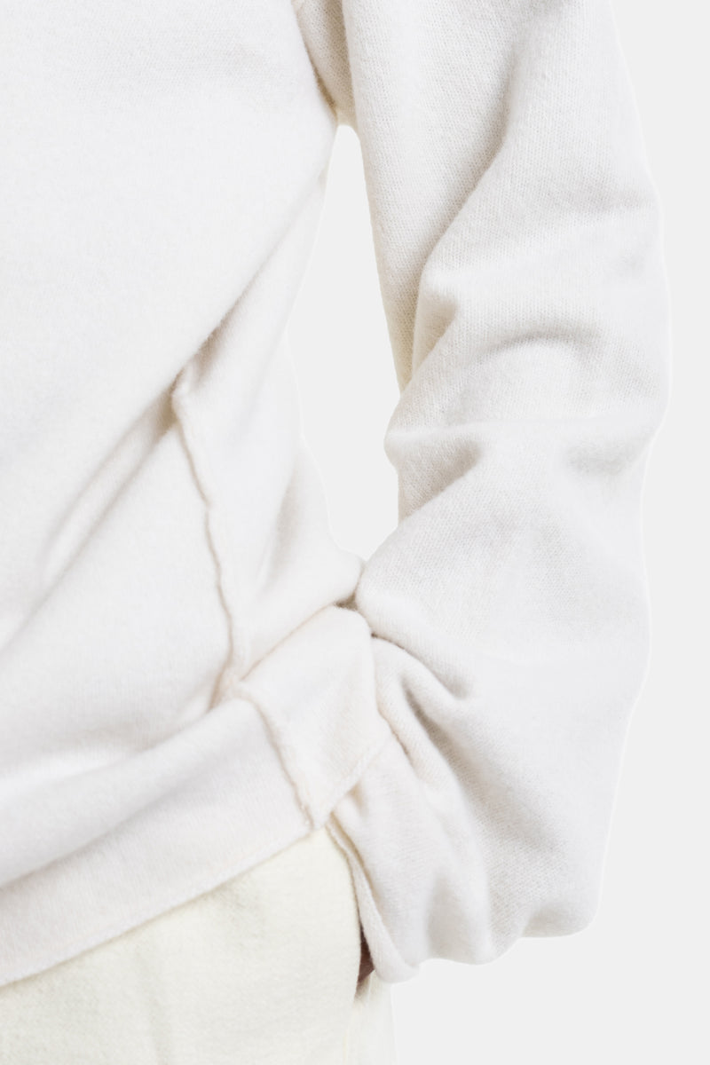 Sofie d'Hoore white wool sweater detailed bottom with a twisted knot, textured fabric and oversized seams