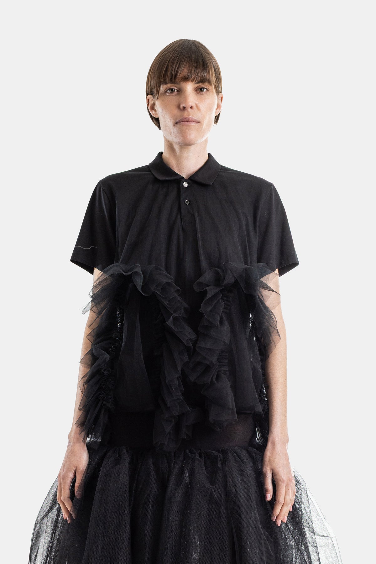 Noir Kei Ninomiya women's black polo shirt with layered tulle ruffles structured and ethereal silhouette SS26