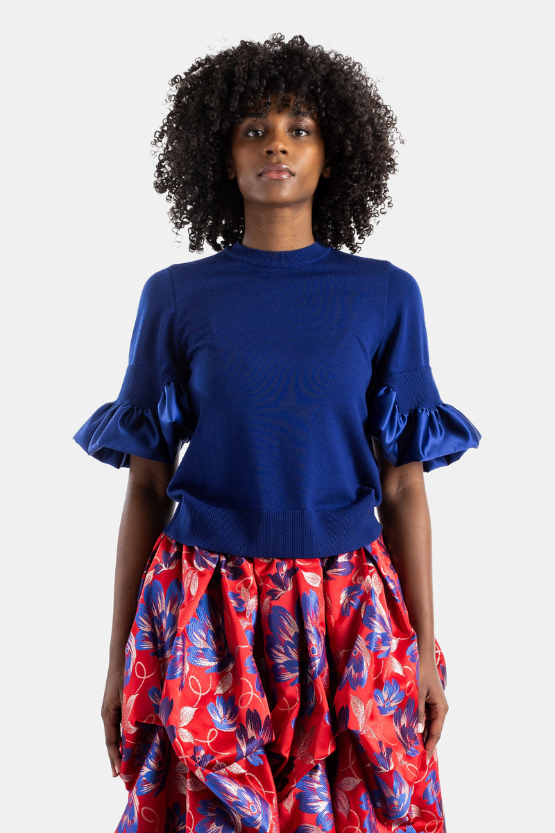 Blue knit top with satin ruffles