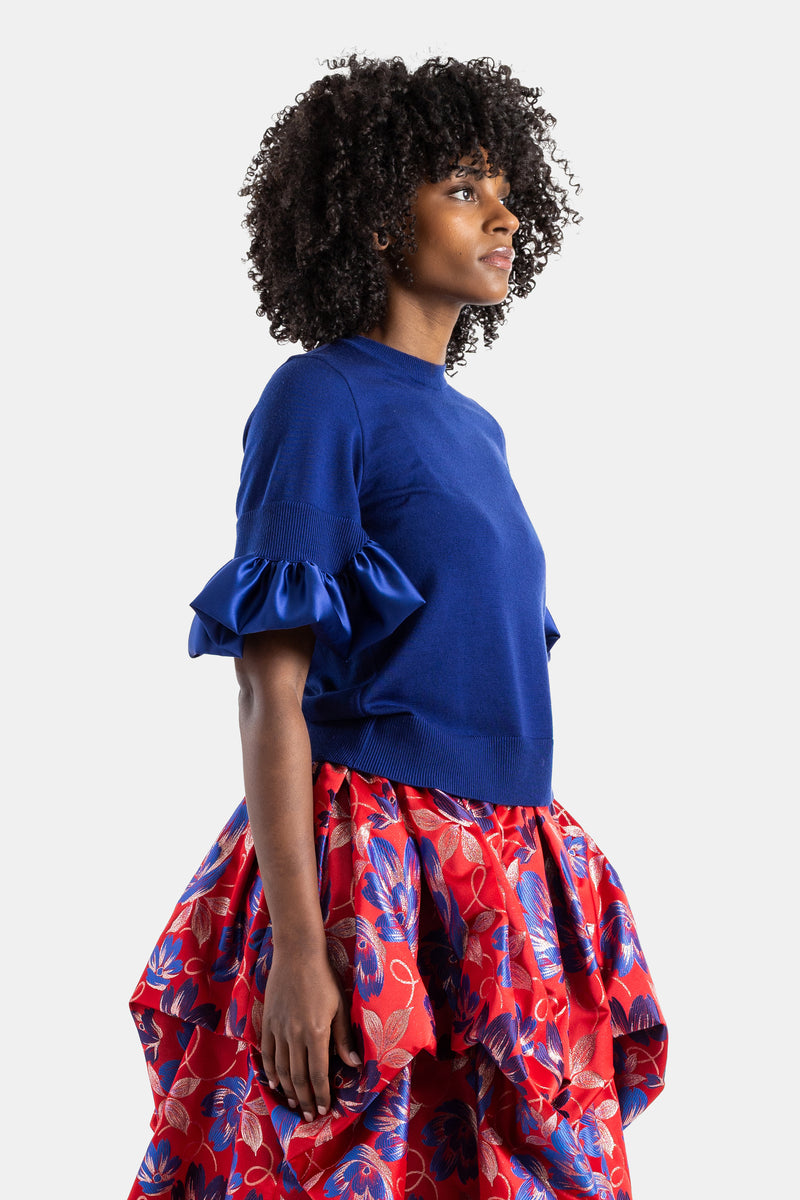 Blue knit top with satin ruffles