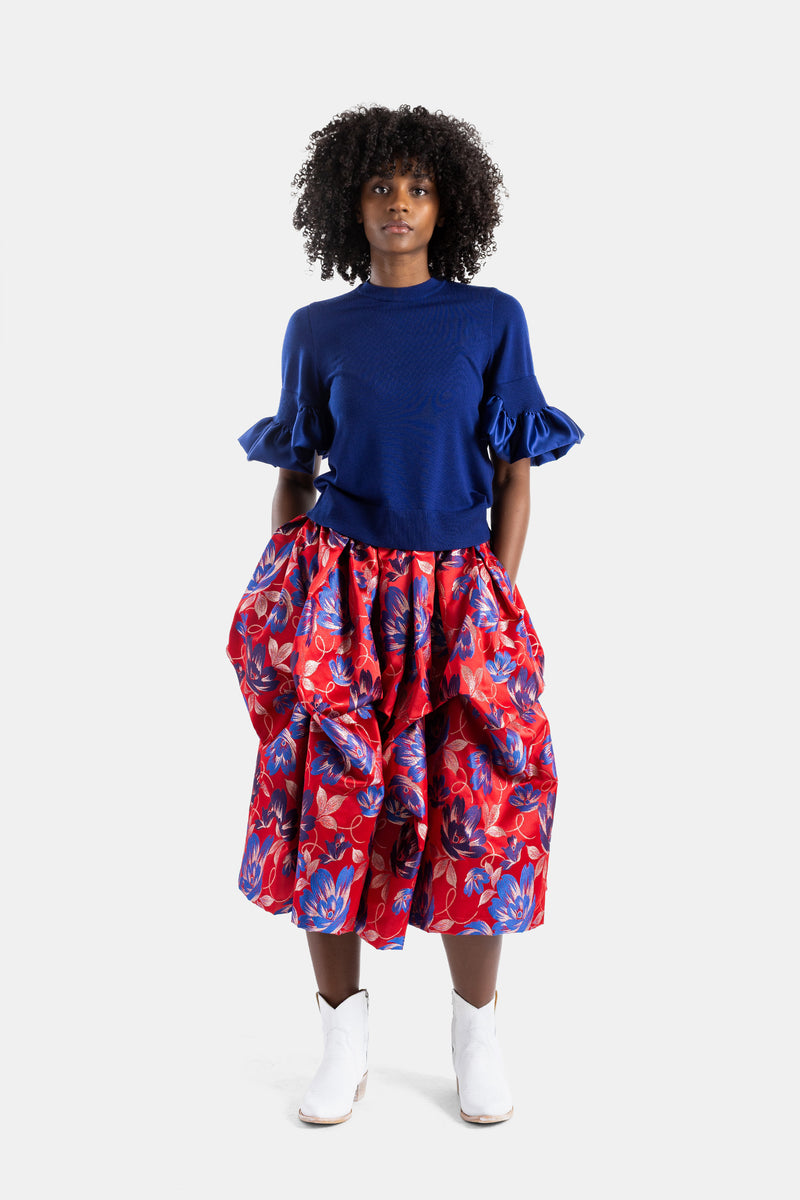 Blue knit top with satin ruffles