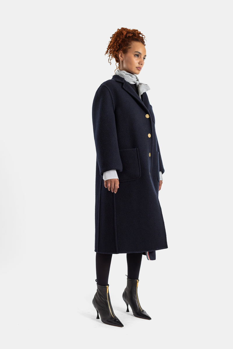 Thom Browne manteau laine bouillie marine, vue profil silhouette longue, poches plaquées et chemise rayée contrastante